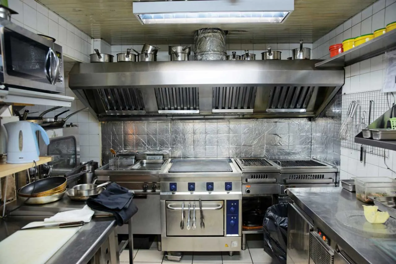 Professional hood cleaning technician servicing a restaurant exhaust system in Salt Lake City